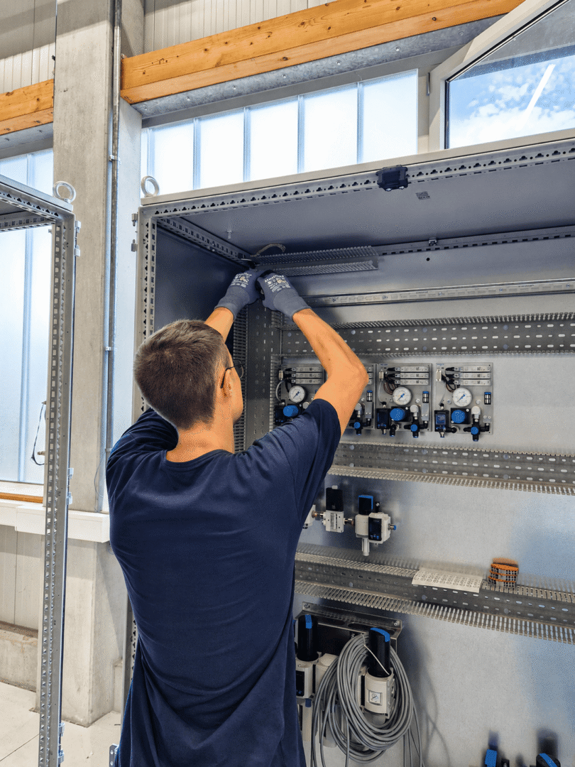 Apprentice Leon works on the control cabinet