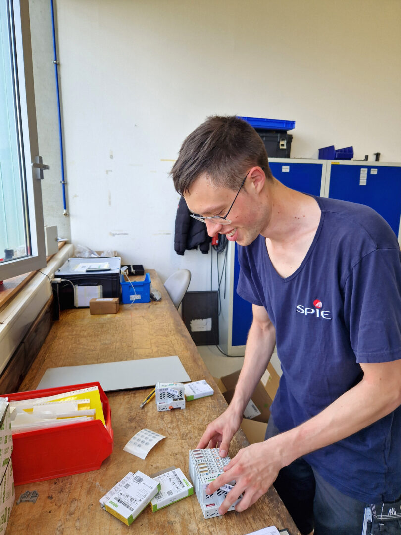 Apprentice Leon works on a switch for the control cabinet